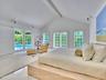 Walls of French doors fill the space with natural light