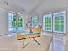 Walls of French doors fill the space with natural light