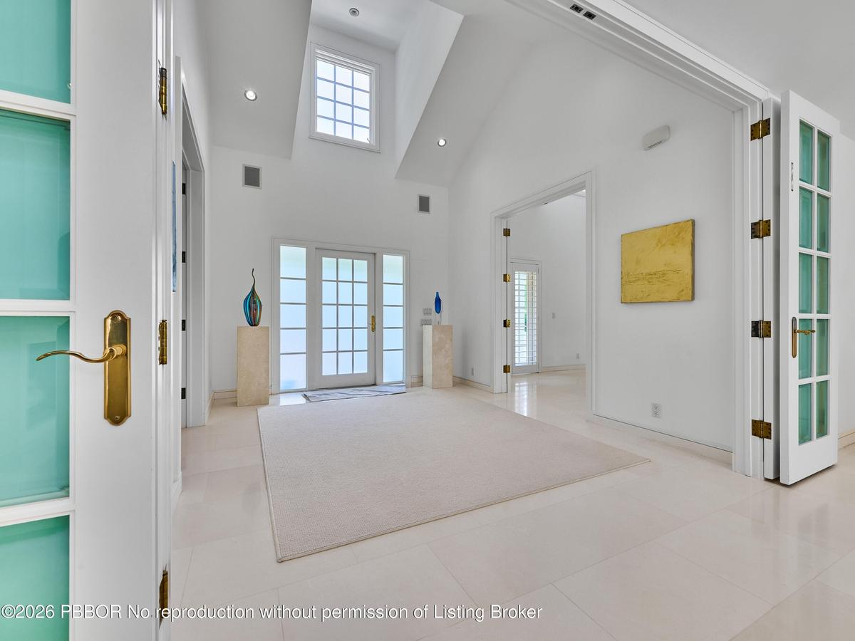 Soaring ceilings and striking architectural volume, create a sophisticated transition from the home's classic Coastal Colonial exterior to its bright,