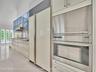 Volume Ceilings, French Doors, Wall of Windows and Dormers bring Natural Light into the Kitchen all day