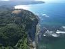 Coastal property featuring expansive ocean frontage, rugged cliffside terrain, and dense mature timberland