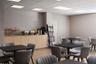 Built-in light-tone wood cabinetry, recessed ceiling lighting, and wood-finish flooring