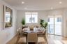 Bright room featuring wood-finish flooring, recessed lighting, a sliding glass door, and large windows with roller shades