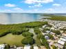 Aerial perspective featuring open water frontage, natural mangrove coastline, and proximity to coastal waterways