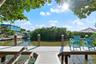 Private wooden dock featuring structural pilings and water access