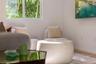 Neutral-toned interior space featuring light wood-finish flooring and a large slider window with exterior greenery