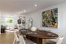 Open-concept interior featuring light wood-finish flooring and recessed ceiling lighting