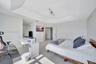 Tray ceiling, wood-finish flooring, and multi-directional track lighting