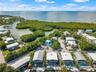 Aerial perspective of a coastal residential property featuring direct water frontage, private boat docking, and a natural mangrove shoreline