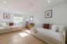 Interior space featuring wood-finish flooring, recessed lighting, and a single-pane window with a roller shade