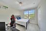 Wood-finish flooring, multi-pane window with custom shade, built-in shelving, triple-bulb track lighting, and a bi-fold closet