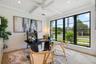 Beamed ceiling with white tongue-and-groove paneling, expansive multi-pane window wall with black frames, porcelain-finish flooring, and integrated re