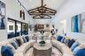 Vaulted ceilings with exposed decorative timber trusses and beadboard paneling, clerestory windows, and large-format tile flooring
