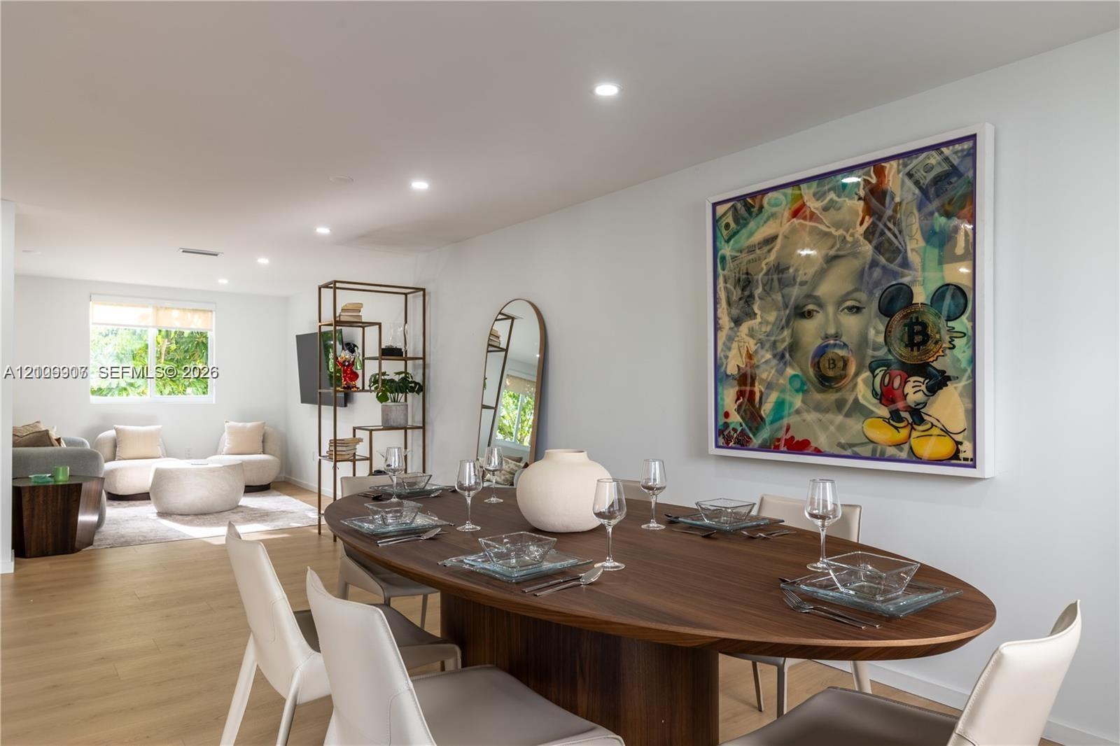 Open-concept interior featuring light wood-finish flooring and recessed ceiling lighting