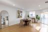 Open-concept living space featuring wood-finish flooring, recessed lighting, and sliding glass doors