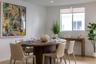 Neutral-toned interior space featuring wood-finish flooring, recessed lighting, and a large sliding window with roller shade