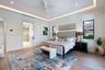 Tray ceiling with recessed lighting, porcelain-finish flooring, sliding interior door, and multi-pane windows with dark framing