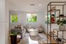 Living area featuring recessed lighting, dual windows with integrated shades, and wood-finish flooring