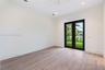 Neutral interior featuring porcelain-finish flooring, recessed lighting, a ceiling fan, and French doors with black frames opening to exterior landsca