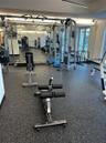 Fitness space featuring impact-resistant rubber flooring, floor-to-ceiling wall mirrors, and recessed lighting