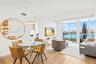 Open-concept professionally remodeled & appointed living space featuring top of the line Porcelanosa wood-finish flooring & floor-to-ceiling windows w