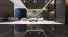 Grand lobby featuring polished stone flooring, dark wood-paneled walls, a suspended slatted ceiling, and an illuminated decorative feature wall