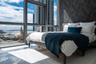 Floor-to-ceiling windows, polished tile flooring, and textured accent wall