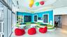 Floor-to-ceiling windows, recessed ceiling lighting, built-in storage shelving, wall-integrated writing surfaces, and multi-level stepped platform flo