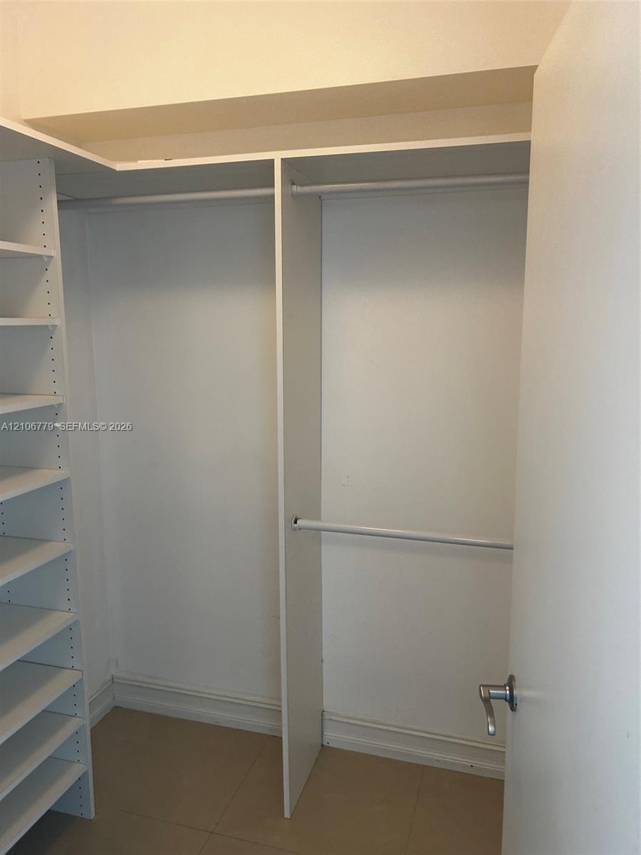 Built-in storage system featuring floor-to-ceiling shelving and dual-tier hanging rods