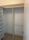 Built-in storage system featuring floor-to-ceiling shelving and dual-tier hanging rods