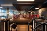 Fitness facility featuring a raised boxing ring, floor-to-ceiling windows, wood-finish flooring, recessed architectural ceiling detail, and integrated
