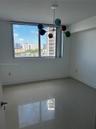 Large-format tile flooring, multi-globe structural light fixture, and floor-to-ceiling window featuring an exterior coastal cityscape