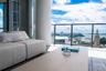 Private balcony featuring tile flooring and a glass-paneled railing