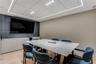 Built-in wall-to-wall cabinetry, recessed ceiling lighting with perimeter illumination, and light-toned wood-finish flooring