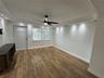 Wood-finish flooring, recessed ceiling lighting, crown molding, and a central ceiling fan