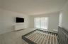 Neutral-toned tile flooring, white walls, and glass sliding doors featuring exterior access to a fenced swimming pool