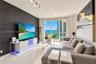 Living area featuring a large format dark tile accent wall, polished tile flooring, glass sliding doors, and adjustable track lighting
