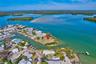 Waterfront lot situated on a peninsula featuring coastal vegetation and direct open water access