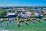 Waterfront property featuring multiple wooden boat docks, thatched-roof structures, and direct water access