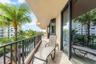 Covered balcony featuring tile flooring and dark metal railing
