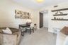Room featuring neutral wall tones, wall-to-wall carpeting, recessed lighting, built-in wooden shelving, and a closet with louvered doors
