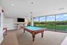 Interior room featuring floor-to-ceiling windows, wall-to-wall carpeting, recessed lighting, and a built-in wooden bar shelf