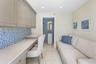 Built-in desk with neutral stone countertop, blue mosaic tile backsplash, recessed ceiling lighting, and tile flooring