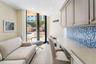 Built-in cabinetry with stone-finish countertops, mosaic tile backsplash, recessed ceiling lighting, and tile flooring, featuring sliding glass doors 