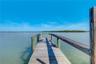 Wooden dock with timber framing and railings extending over the water