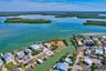 Waterfront parcel situated on a peninsula, featuring direct coastal access and mature palm trees