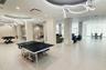 Expansive open-concept floor plan featuring large-format tile flooring, sculptural LED pendant lighting, and recessed circular ceiling detailing