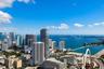 High-altitude urban perspective featuring expansive coastal scenery, waterfront exposure, and a dense cityscape skyline