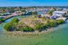 Waterfront parcel featuring direct canal access, mature palm trees, and native coastal vegetation