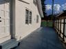 Stucco exterior featuring dual-pane windows, a solid-core exterior door, concrete surface, and perimeter fencing